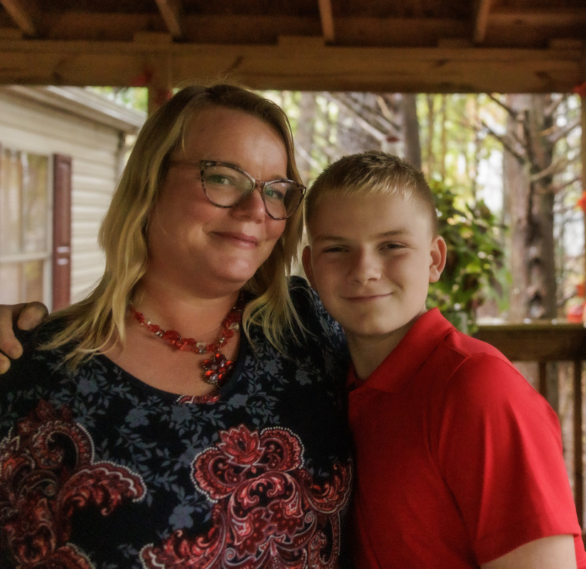 Woman and her son standing on their coveredndeck outside