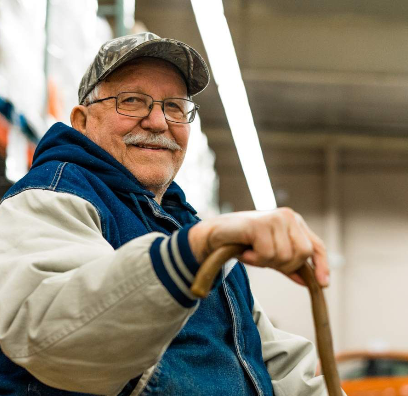 Older man sitting in a warehouse